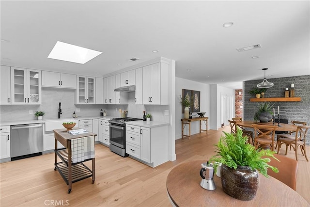1804 Deer Canyon Rd, Arroyo Grande, CA 93420 - kitchen with appliances with stainless steel finishes, a sink, under cabinet range hood, light countertops, and recessed lighting