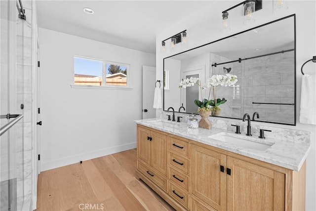1804 Deer Canyon Rd, Arroyo Grande, CA 93420 - bathroom with baseboards, a shower with door, double vanity, and wood finished floors