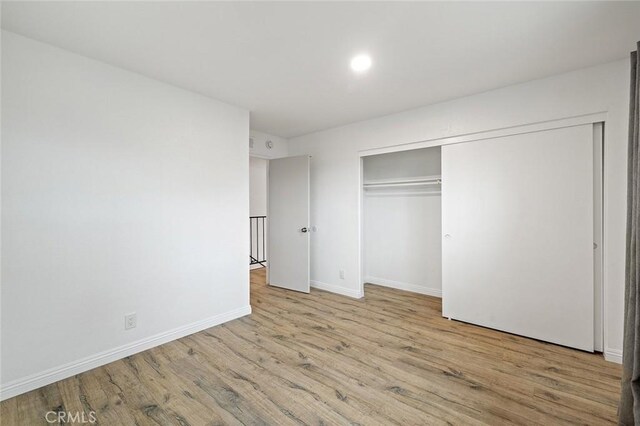 128 Fairview St Unit 1, Santa Ana, CA 92704 - unfurnished bedroom with wood finished floors, baseboards, and a closet