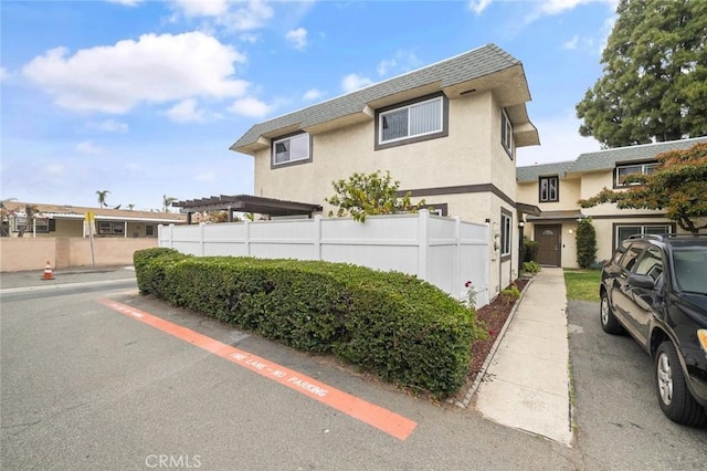 128 Fairview St Unit 1, Santa Ana, CA 92704 - multi unit property featuring fence, stucco siding, and roof with shingles