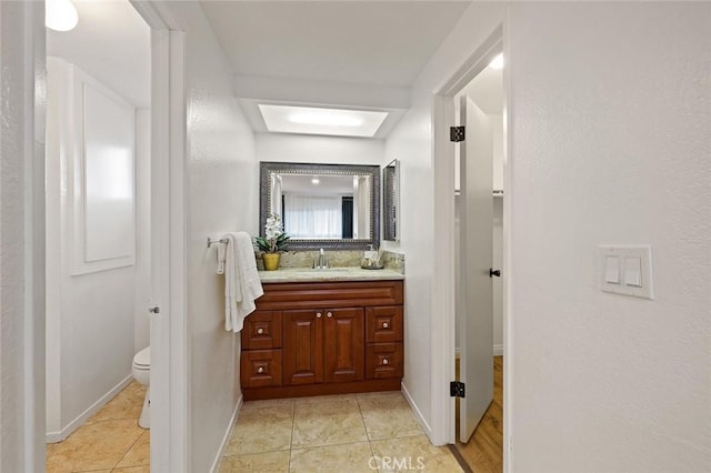 128 Fairview St Unit 1, Santa Ana, CA 92704 - bathroom featuring vanity, tile patterned flooring, toilet, and baseboards