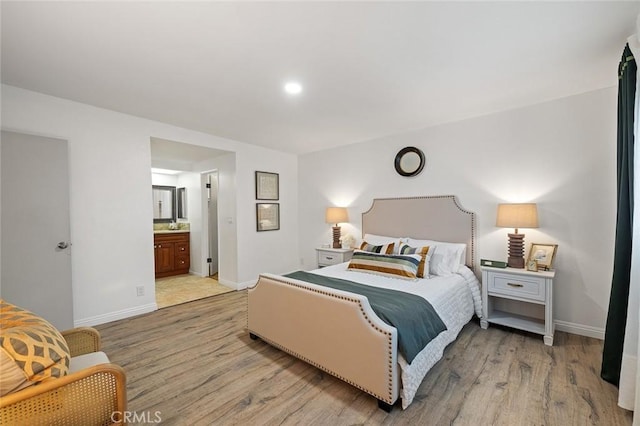 128 Fairview St Unit 1, Santa Ana, CA 92704 - bedroom with light wood-style flooring, baseboards, and connected bathroom
