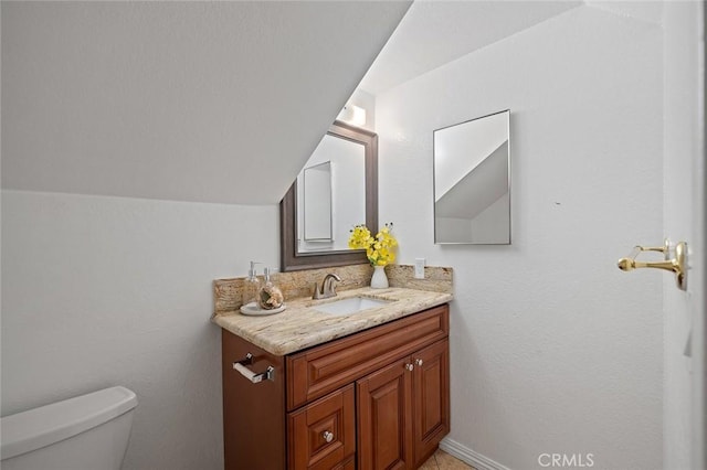 128 Fairview St Unit 1, Santa Ana, CA 92704 - bathroom with toilet, vanity, and vaulted ceiling