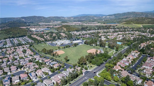 aerial overview of property's location featuring mountains and nearby suburban area