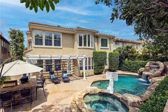 view of pool with a patio area, a pergola, and a pool with connected hot tub