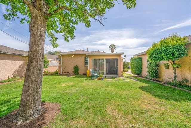 10608 Beak Ave, South Gate, CA 90280 - rear view of house featuring stucco siding and a sunroom