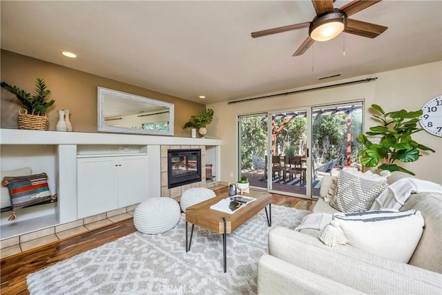 15632 Little Peak Rd, Hidden Valley Lake, CA 95467 - living room with wood finished floors, a tiled fireplace, ceiling fan, and recessed lighting