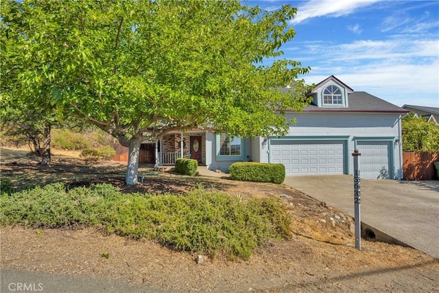 15632 Little Peak Rd, Hidden Valley Lake, CA 95467 - obstructed view of property with a garage, covered porch, and concrete driveway