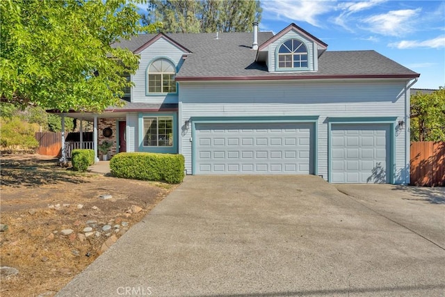 15632 Little Peak Rd, Hidden Valley Lake, CA 95467 - view of front of home featuring concrete driveway, fence, covered porch, a garage, and roof with shingles