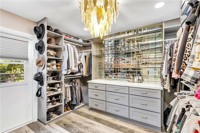 22602 Manalastas Dr, Lake Forest, CA 92630 - spacious closet featuring a chandelier and light wood-style flooring