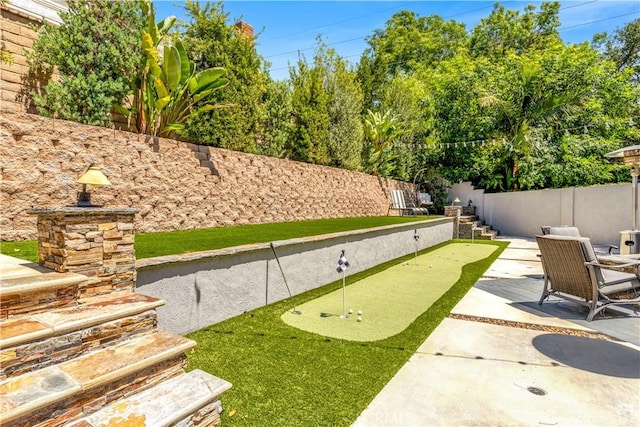 22602 Manalastas Dr, Lake Forest, CA 92630 - view of yard featuring an area to practice putting, a patio area, and fence