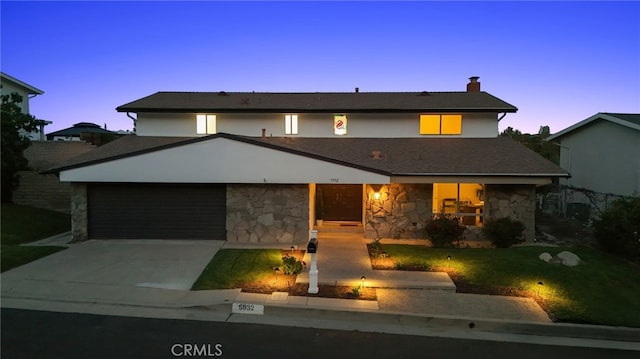 5932 Ellenview Ave, Woodland Hills, CA 91367 - view of front of property featuring stone siding, concrete driveway, an attached garage, a lawn, and a chimney