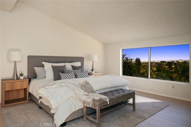 5932 Ellenview Ave, Woodland Hills, CA 91367 - bedroom featuring wood finished floors, vaulted ceiling, and baseboards