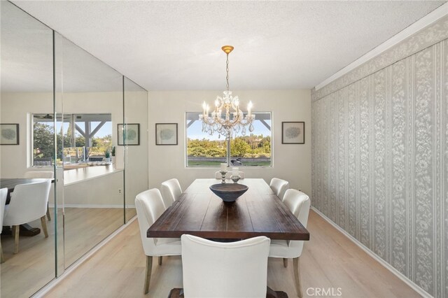 5932 Ellenview Ave, Woodland Hills, CA 91367 - dining room featuring light wood finished floors, a chandelier, baseboards, and a textured ceiling