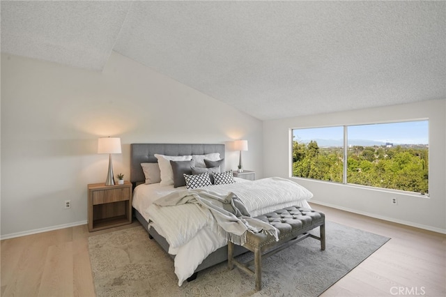 5932 Ellenview Ave, Woodland Hills, CA 91367 - bedroom featuring a textured ceiling, wood finished floors, baseboards, and lofted ceiling