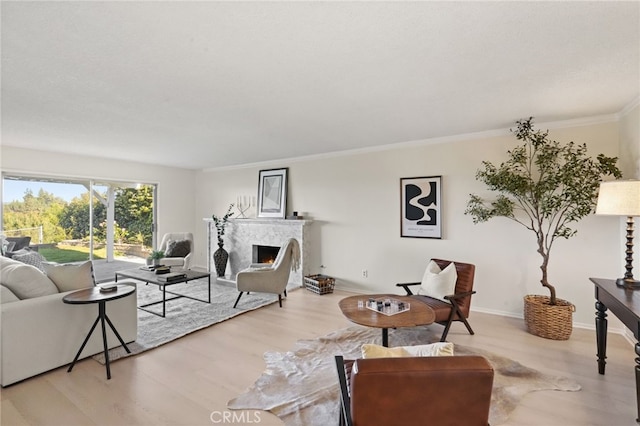 5932 Ellenview Ave, Woodland Hills, CA 91367 - living room with wood finished floors, a warm lit fireplace, ornamental molding, and baseboards