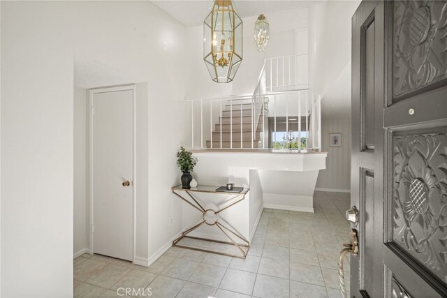 5932 Ellenview Ave, Woodland Hills, CA 91367 - entryway with a chandelier, baseboards, light tile patterned flooring, and stairway
