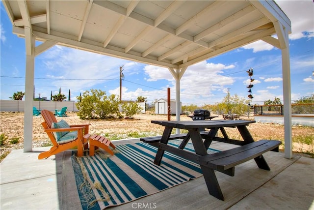 3872 Balsa Ave, Yucca Valley, CA 92284 - view of patio / terrace with a storage unit, an outbuilding, and fence