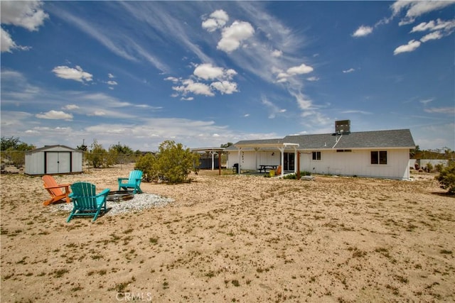 3872 Balsa Ave, Yucca Valley, CA 92284 - rear view of house featuring a storage unit and an outbuilding