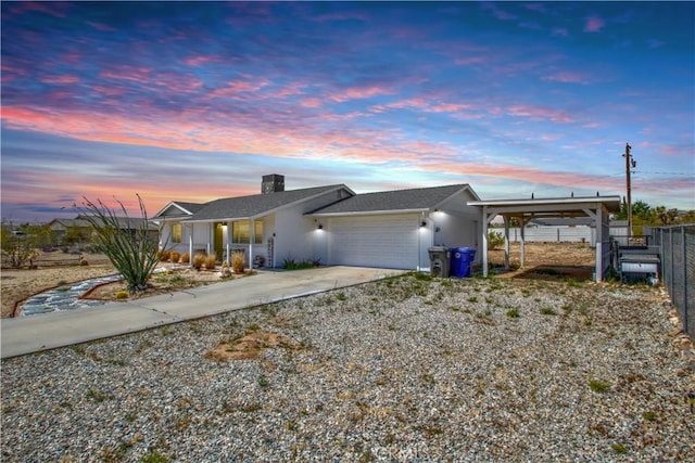 3872 Balsa Ave, Yucca Valley, CA 92284 - view of front facade with an attached garage, fence, concrete driveway, a chimney, and a porch