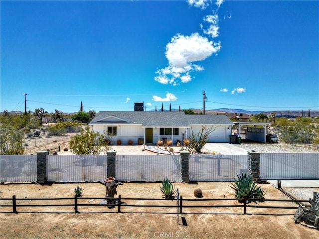 3872 Balsa Ave, Yucca Valley, CA 92284 - ranch-style house with a fenced front yard, an attached garage, driveway, and roof with shingles