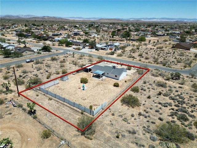 3872 Balsa Ave, Yucca Valley, CA 92284 - aerial perspective of suburban area featuring property boundaries highlighted, mountains, and a desert landscape