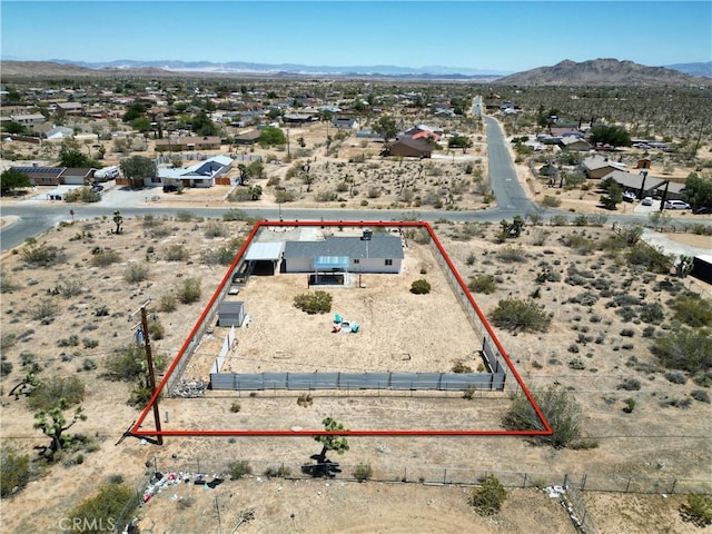 3872 Balsa Ave, Yucca Valley, CA 92284 - aerial perspective of suburban area featuring property parcel outlined, mountains, and a desert landscape