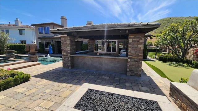 31820 Paseo Tarazona, San Juan Capistrano, CA 92675 - view of patio / terrace with a putting green, fence, and a pool with connected hot tub