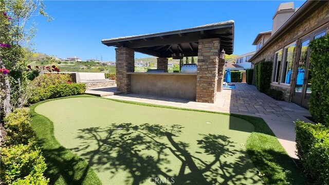 31820 Paseo Tarazona, San Juan Capistrano, CA 92675 - view of patio featuring a putting area, a gazebo, fence, and a bar