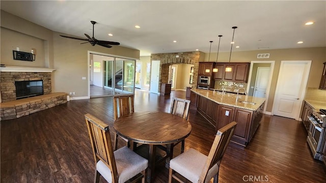31820 Paseo Tarazona, San Juan Capistrano, CA 92675 - dining room with a ceiling fan, dark wood-type flooring, a fireplace, baseboards, and recessed lighting