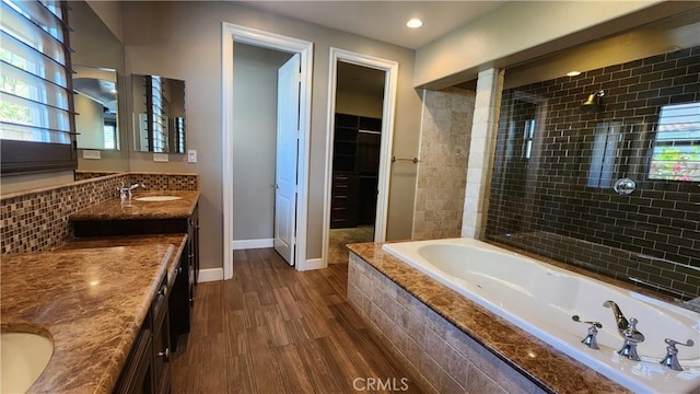 31820 Paseo Tarazona, San Juan Capistrano, CA 92675 - bathroom with wood finished floors, double vanity, a relaxing tiled tub, healthy amount of natural light, and recessed lighting