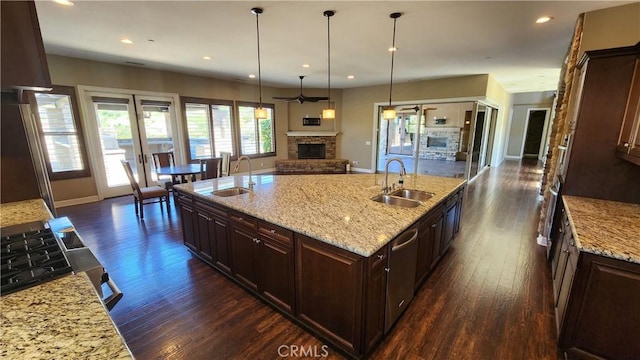 31820 Paseo Tarazona, San Juan Capistrano, CA 92675 - kitchen featuring a sink, open floor plan, a fireplace with raised hearth, dark wood finished floors, and recessed lighting