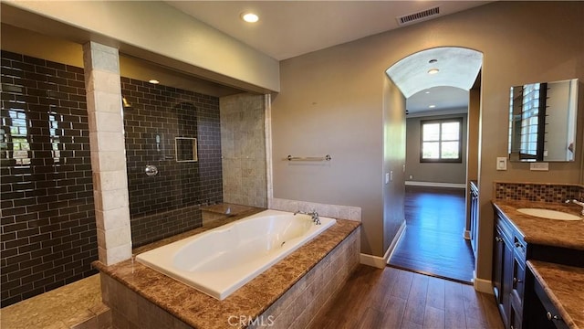 31820 Paseo Tarazona, San Juan Capistrano, CA 92675 - full bathroom with wood finished floors, a bath, tiled shower, vanity, and baseboards
