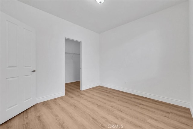 12455 Benton Dr Unit 2, Rancho Cucamonga, CA 91739 - unfurnished bedroom with light wood finished floors, baseboards, a spacious closet, and a closet