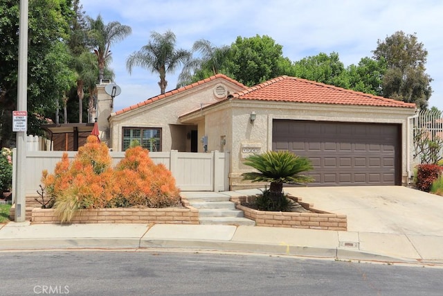 10260 Santa Rosa Ct, Rancho Cucamonga, CA 91730 - mediterranean / spanish-style house with a tile roof, driveway, an attached garage, and stucco siding