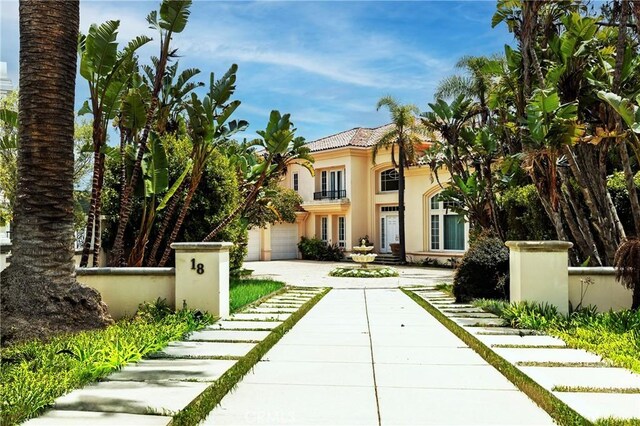 18 Morning View Dr, Newport Coast, CA 92657 - mediterranean / spanish-style house featuring stucco siding, driveway, a garage, and a tile roof