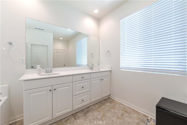 14991 Cavetto Ln, Fontana, CA 92336 - full bathroom featuring baseboards, double vanity, healthy amount of natural light, and recessed lighting