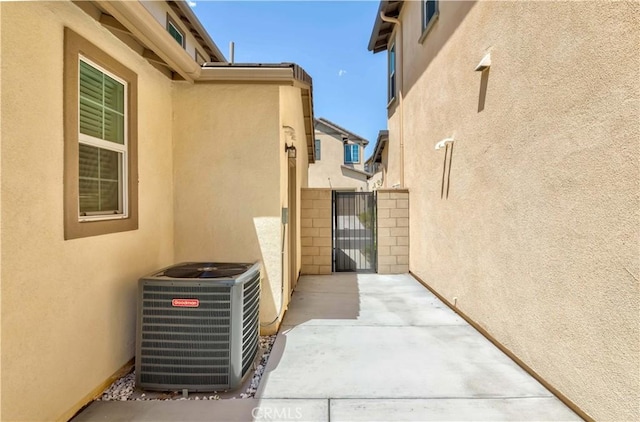 14991 Cavetto Ln, Fontana, CA 92336 - view of patio featuring central AC unit and a gate