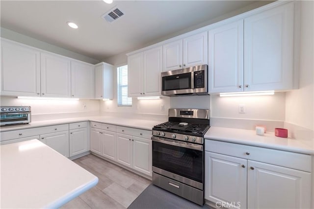 14991 Cavetto Ln, Fontana, CA 92336 - kitchen featuring stainless steel appliances, white cabinetry, recessed lighting, light countertops, and light wood finished floors