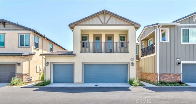 14991 Cavetto Ln, Fontana, CA 92336 - view of front of home with an attached garage, board and batten siding, brick siding, and a balcony