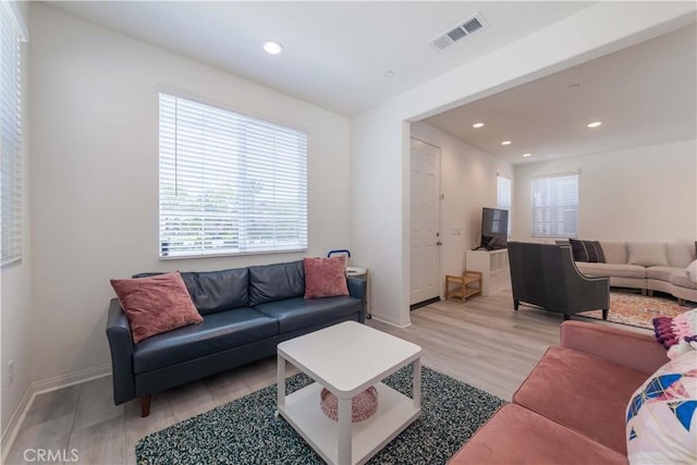14991 Cavetto Ln, Fontana, CA 92336 - living room with healthy amount of natural light, recessed lighting, light wood-style floors, and baseboards