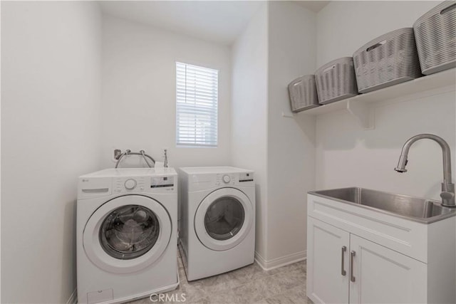 14991 Cavetto Ln, Fontana, CA 92336 - clothes washing area with washing machine and dryer, a sink, and baseboards