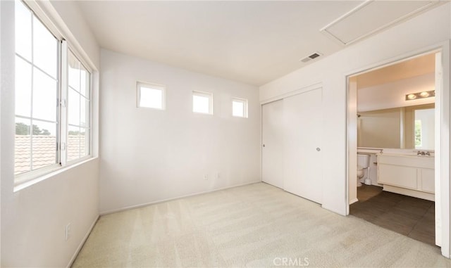 4919 Oakhurst Ave, Banning, CA 92220 - unfurnished bedroom featuring carpet flooring, a closet, ensuite bathroom, and a sink