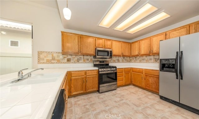 4919 Oakhurst Ave, Banning, CA 92220 - kitchen featuring stainless steel appliances, a sink, a peninsula, backsplash, and ornamental molding