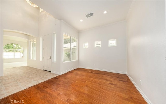4919 Oakhurst Ave, Banning, CA 92220 - empty room with ornamental molding, wood finished floors, recessed lighting, baseboards, and arched walkways