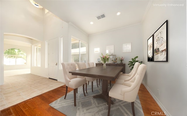 4919 Oakhurst Ave, Banning, CA 92220 - dining space featuring ornamental molding, wood finished floors, recessed lighting, arched walkways, and baseboards