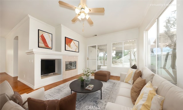 4919 Oakhurst Ave, Banning, CA 92220 - living room with wood finished floors, ornamental molding, ceiling fan, arched walkways, and baseboards