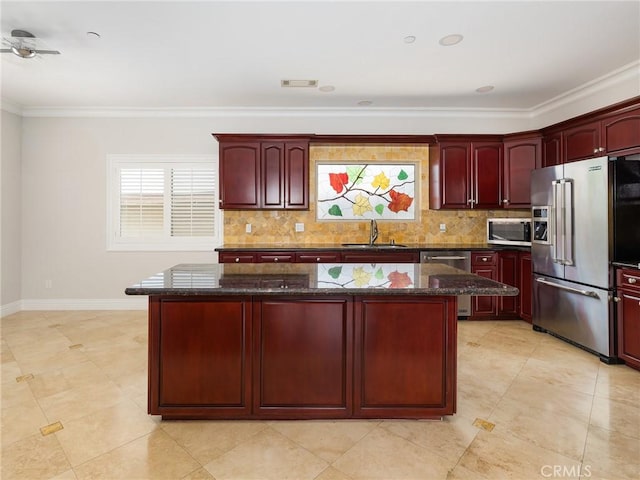 229 N Juanita Ave Unit B, Redondo Beach, CA 90277 - kitchen with reddish brown cabinets, stainless steel appliances, a sink, crown molding, and a center island