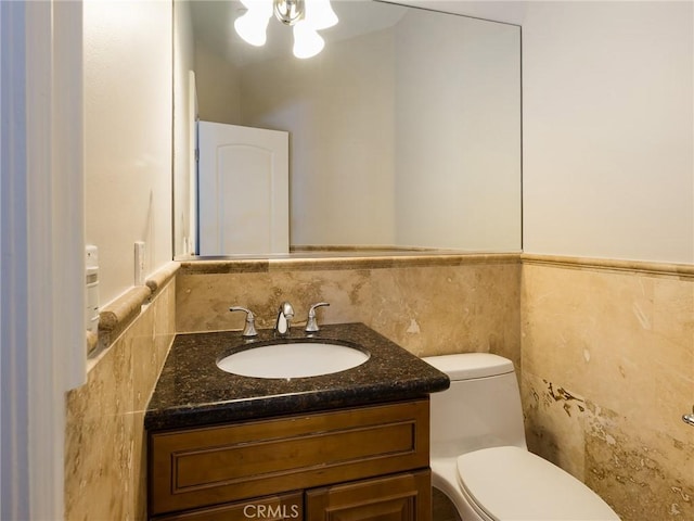 229 N Juanita Ave Unit B, Redondo Beach, CA 90277 - half bath featuring tile walls, vanity, toilet, and wainscoting