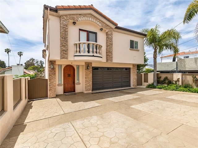 229 N Juanita Ave Unit B, Redondo Beach, CA 90277 - mediterranean / spanish house with a balcony, a gate, stucco siding, an attached garage, and driveway